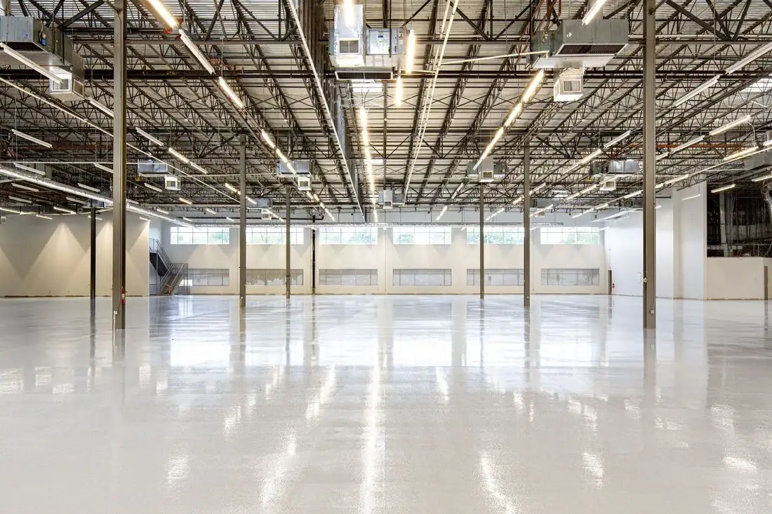 Large empty warehouse with a smooth concrete floor
