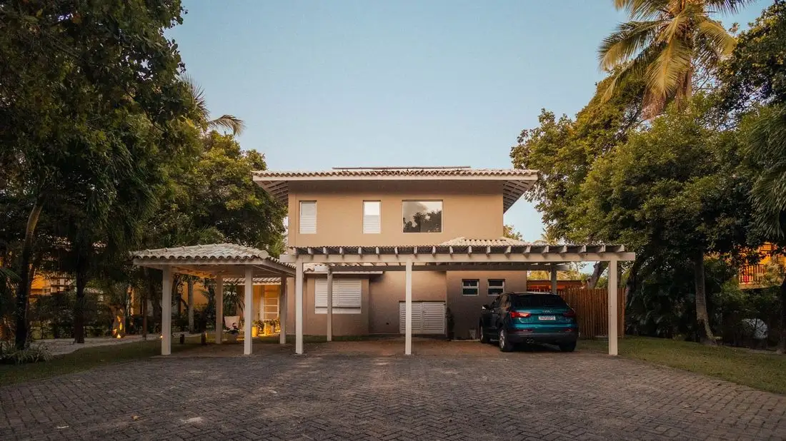 House with a carport and concrete apron among trees
